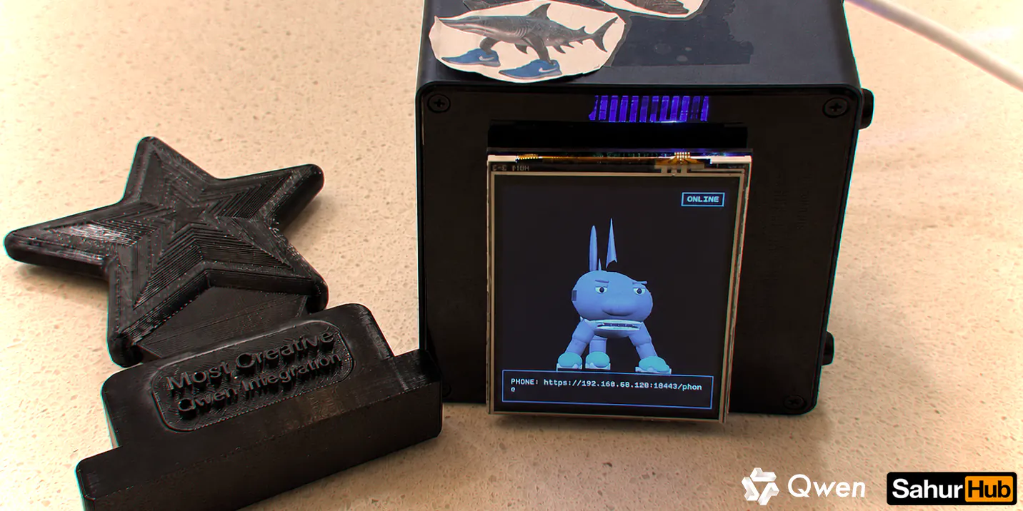 SahurHub on a desk: its 3D character on a small screen, beside the black star trophy it won.